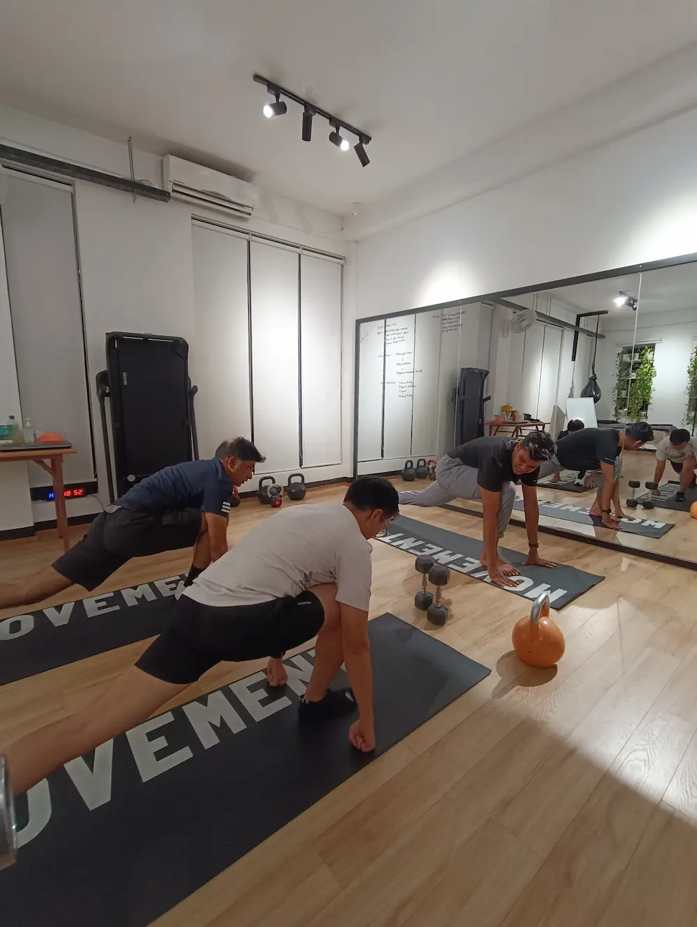 Physiotherapist guiding participants through safe strength training exercises in Phnom Penh