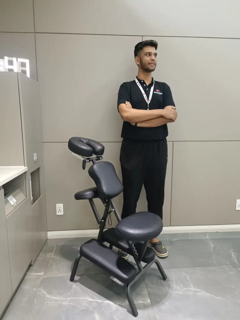  A portable massage chair set up in a modern office environment, ready for employee treatments.
