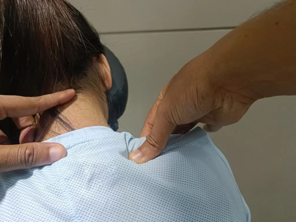 Employee receiving a neck and shoulder massage during a workplace wellness event in Phnom Penh
